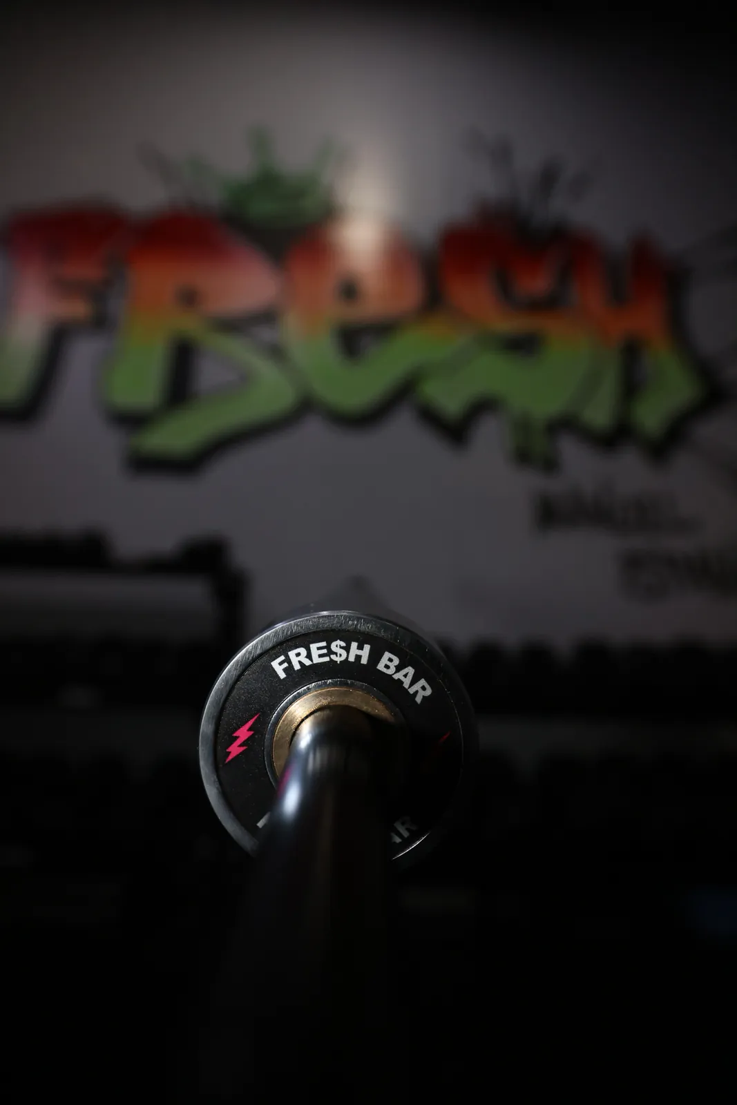 The Fresh Bar end cap, red bolts, in front of the FRESH mural at SPS Fit, seen from the floor.