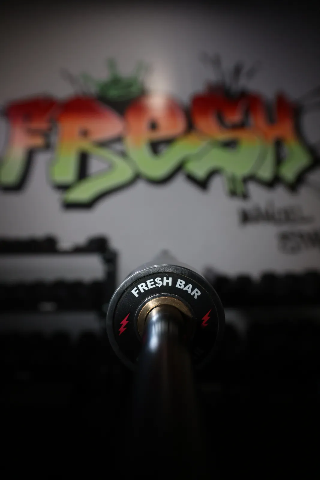 The Fresh Bar end cap, red lightning bolts, in front of the FRESH mural at SPS Fit.