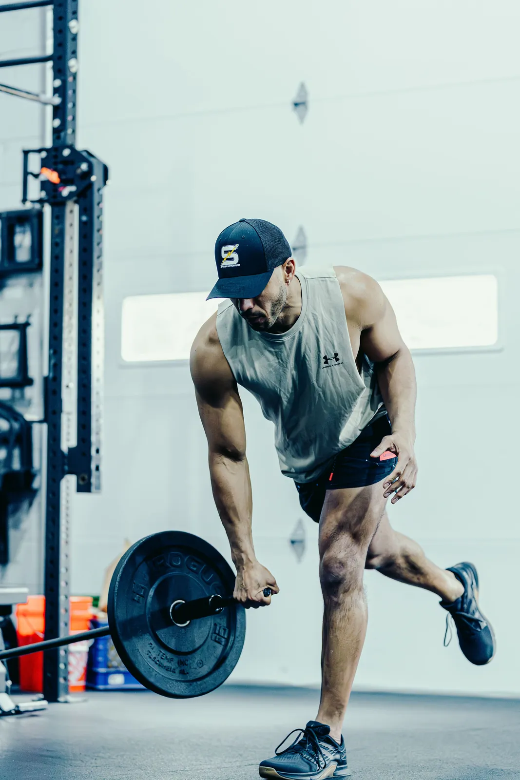 An athlete pulling a single-arm landmine deadlift with the Melo Bar.