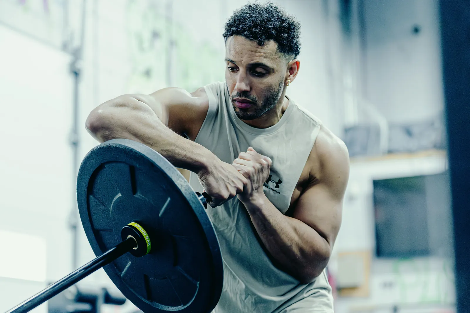 An athlete holding the loaded Melo Bar at his chest in the gym.