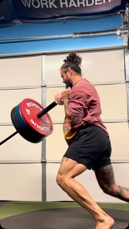 Reel cover: an athlete sprinting with a loaded landmine bar, Work Harder on the wall behind.