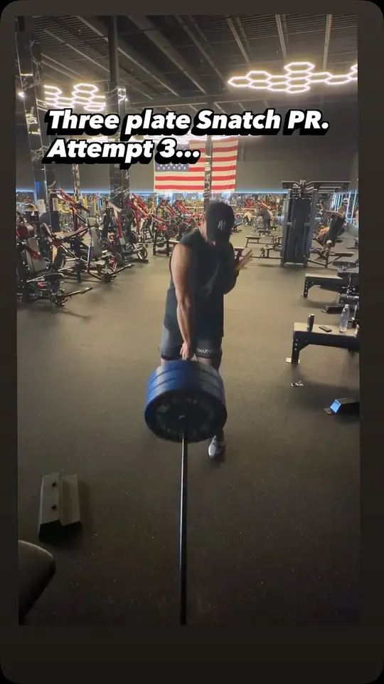 Reel cover: a lifter set for a three-plate landmine snatch in a large gym, titled Three plate snatch PR, attempt 3.